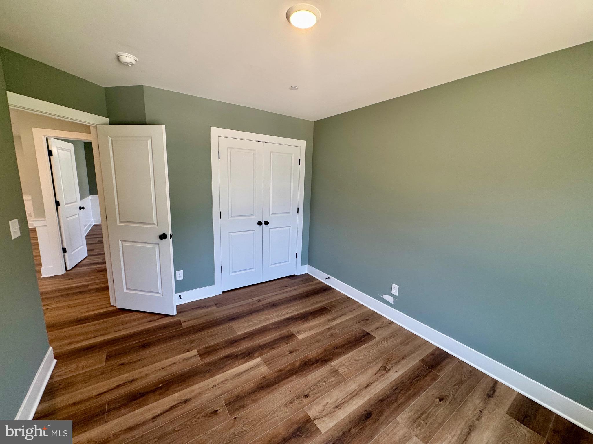 222 Long Point Road Stevensville, MD 21666 - Photo 23 of 44 a view of a room with wooden floor and a bathroom