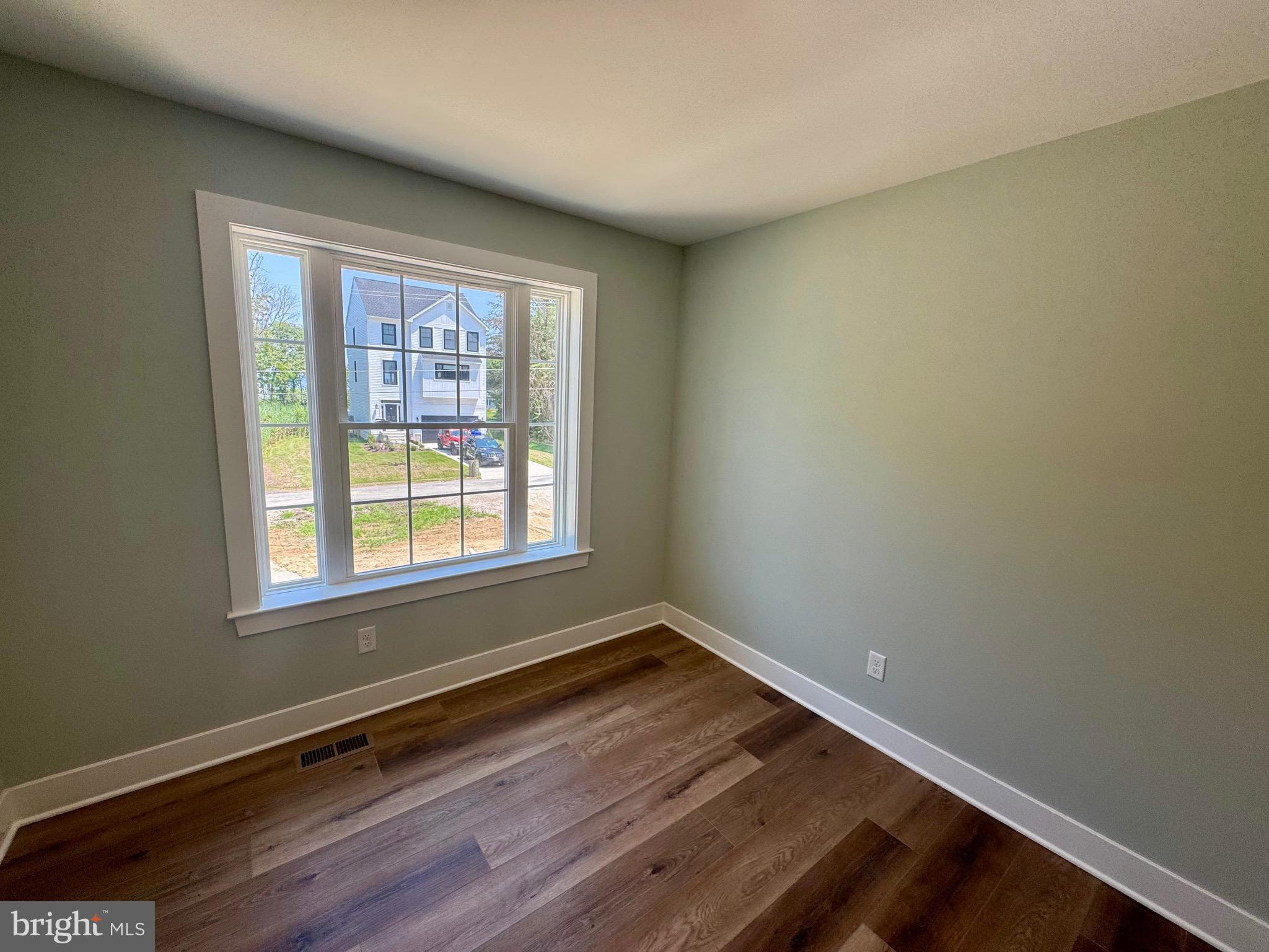 222 Long Point Road Stevensville, MD 21666 - Photo 24 of 44 a view of an empty room with wooden floor and a window
