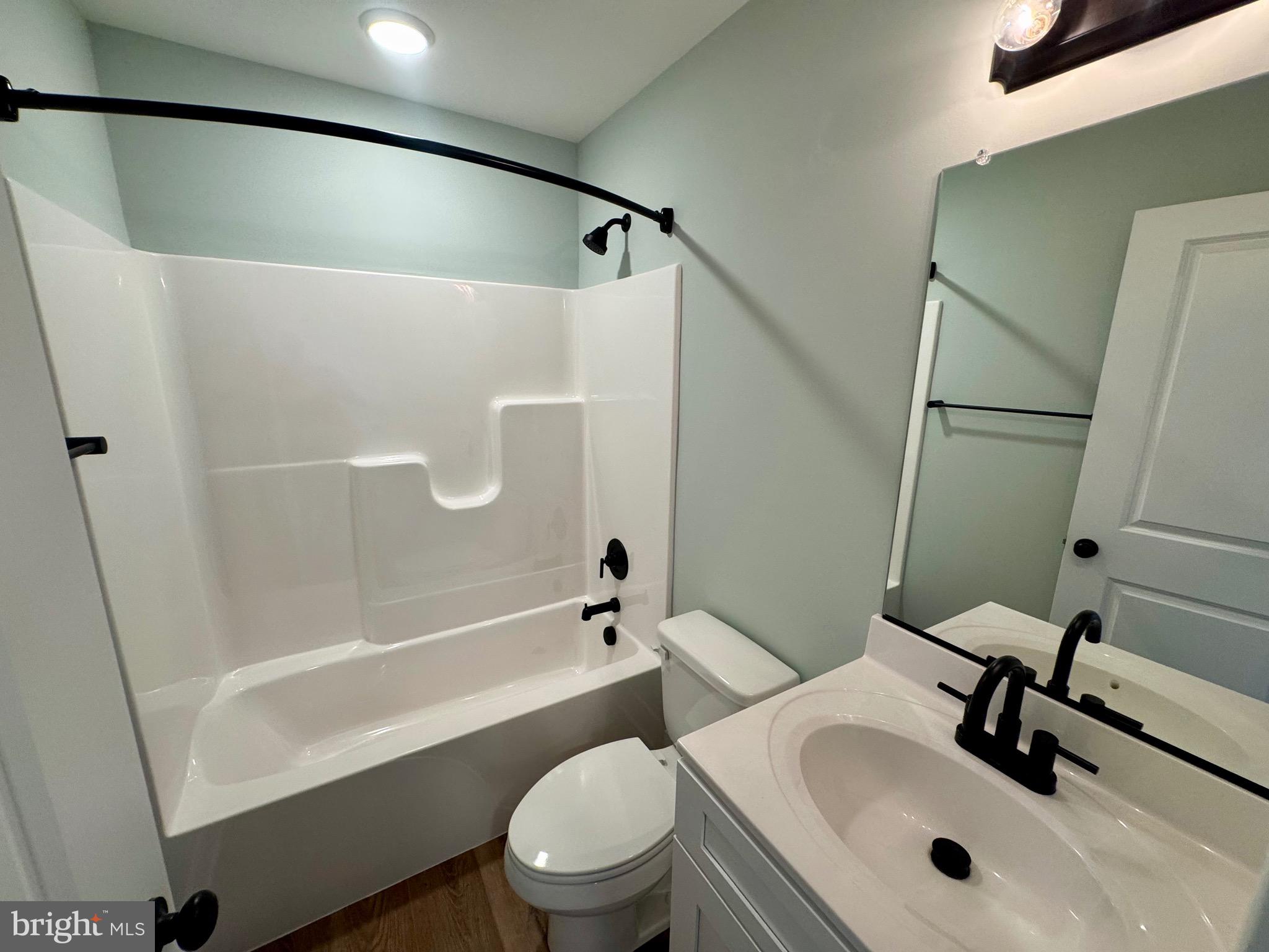 222 Long Point Road Stevensville, MD 21666 - Photo 26 of 44 a bathroom with a sink mirror bathtub and toilet