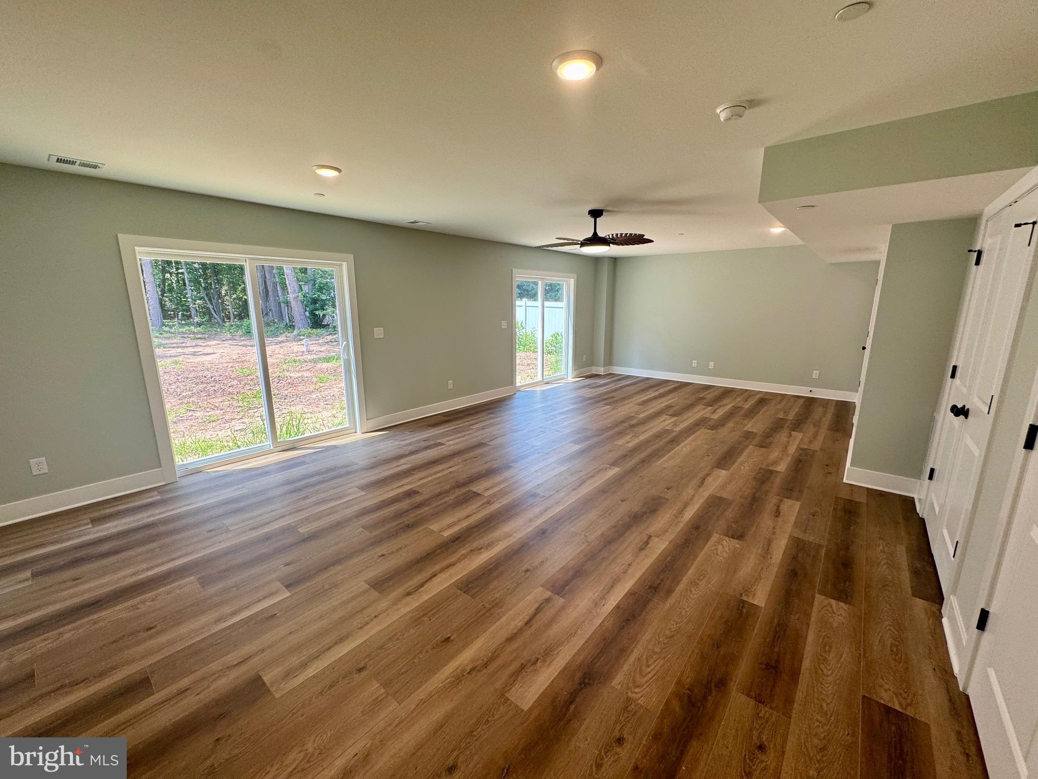 222 Long Point Road Stevensville, MD 21666 - Photo 30 of 44 an empty room with wooden floor and windows