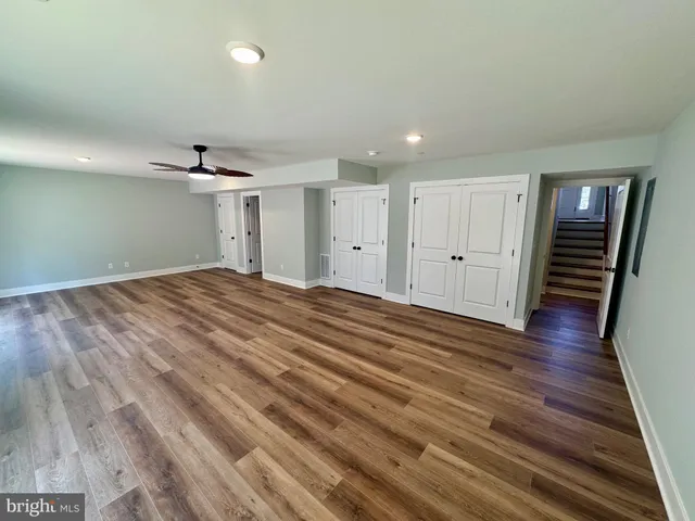 a view of a room with wooden floor