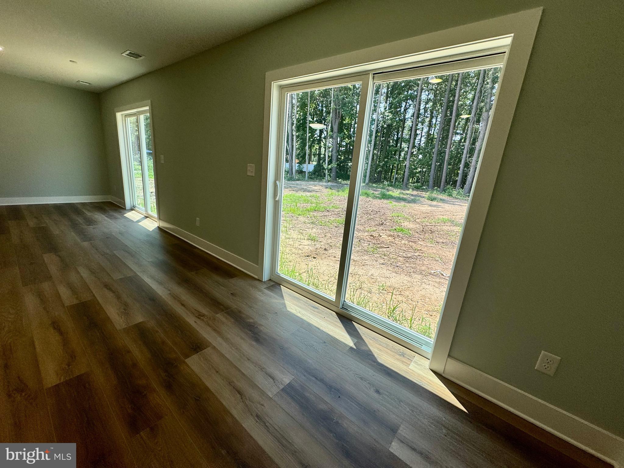 222 Long Point Road Stevensville, MD 21666 - Photo 32 of 44 a view of an empty room with wooden floor and a window