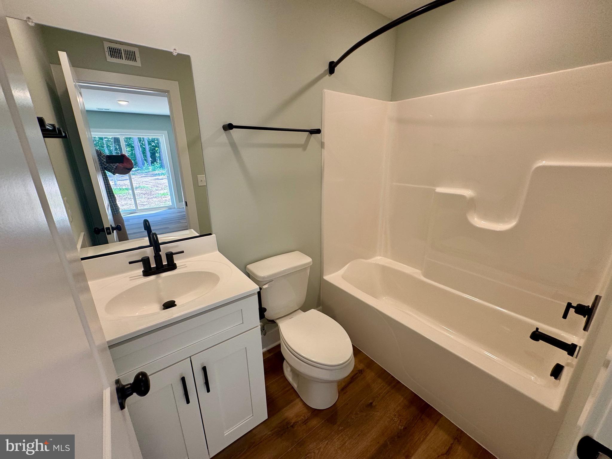 222 Long Point Road Stevensville, MD 21666 - Photo 34 of 44 a bathroom with a sink a toilet and a mirror