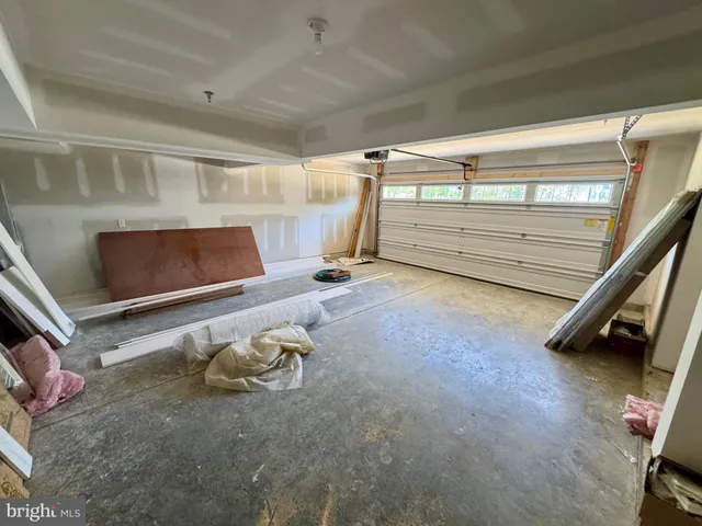 a view of a white house with a big yard and large trees