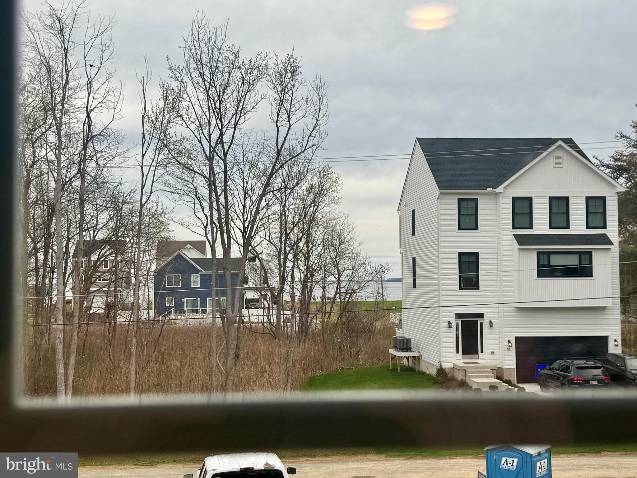 222 Long Point Road Stevensville, MD 21666 - Photo 40 of 44 a view of a white house with a big yard and large trees