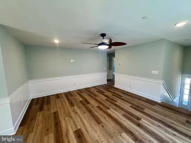 a kitchen with stainless steel appliances granite countertop a refrigerator a stove a sink and a microwave