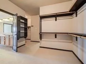 a view of a livingroom with a ceiling fan and window