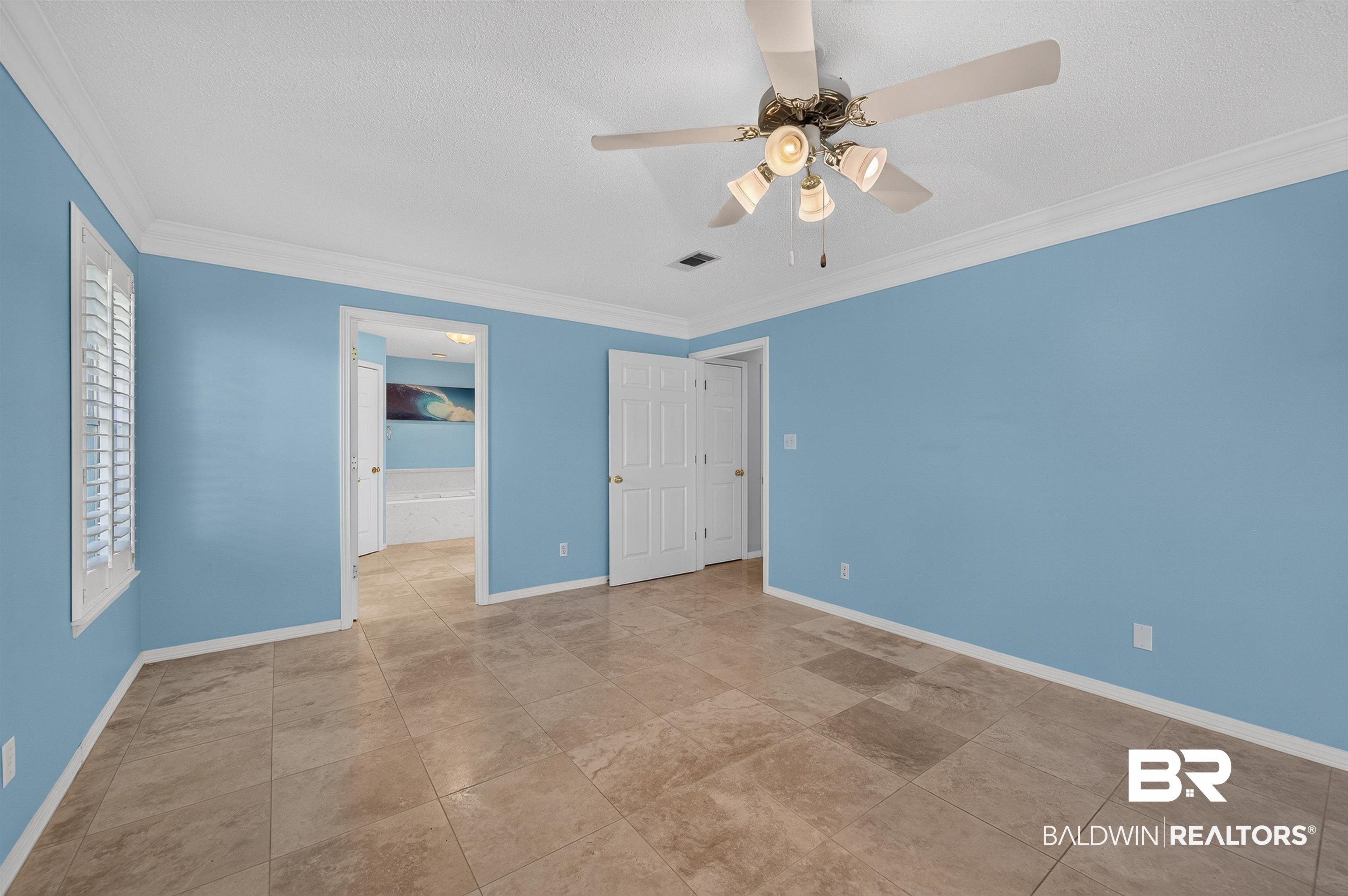 22685 County Road 12 Foley, AL 36535 - Photo 52 of 89 Spacious room featuring neutral tile flooring and crown molding