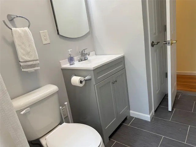 a white toilet sitting next to a bathroom sink
