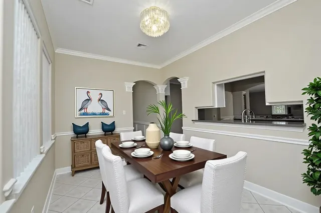 a view of a dining room with furniture and chandelier