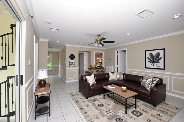 a living room with furniture and wooden floor