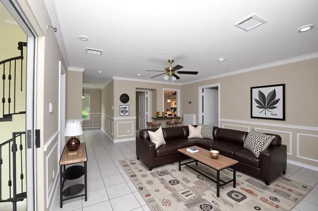 a living room with furniture and wooden floor