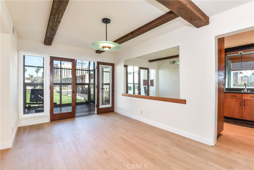 1141 17th Street, Unit 5 Santa Monica, CA 90403 - Photo 16 of 43 a view of an empty room with wooden floor and a window