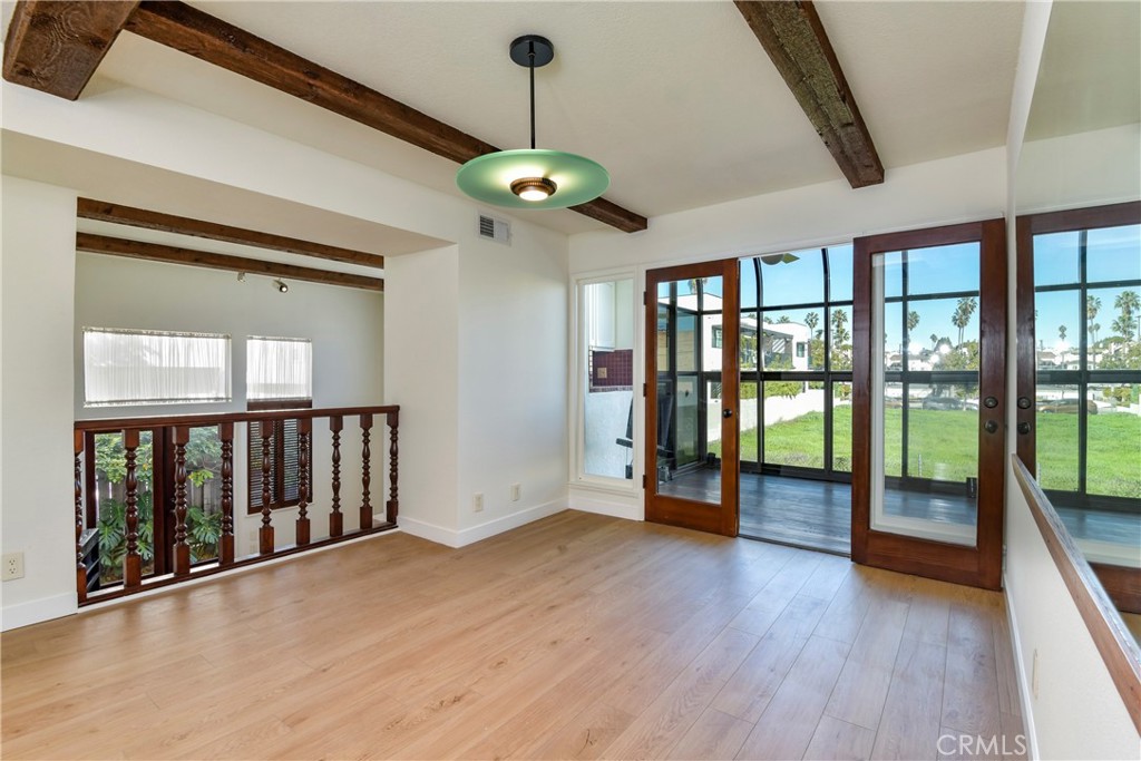 1141 17th Street, Unit 5 Santa Monica, CA 90403 - Photo 17 of 43 a view of an empty room with a window and wooden floor