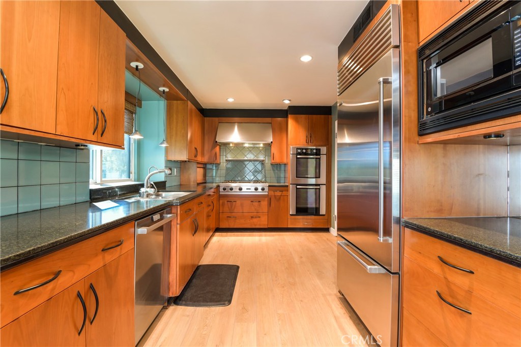 1141 17th Street, Unit 5 Santa Monica, CA 90403 - Photo 21 of 43 a large kitchen with stainless steel appliances kitchen island a large counter top and a stove