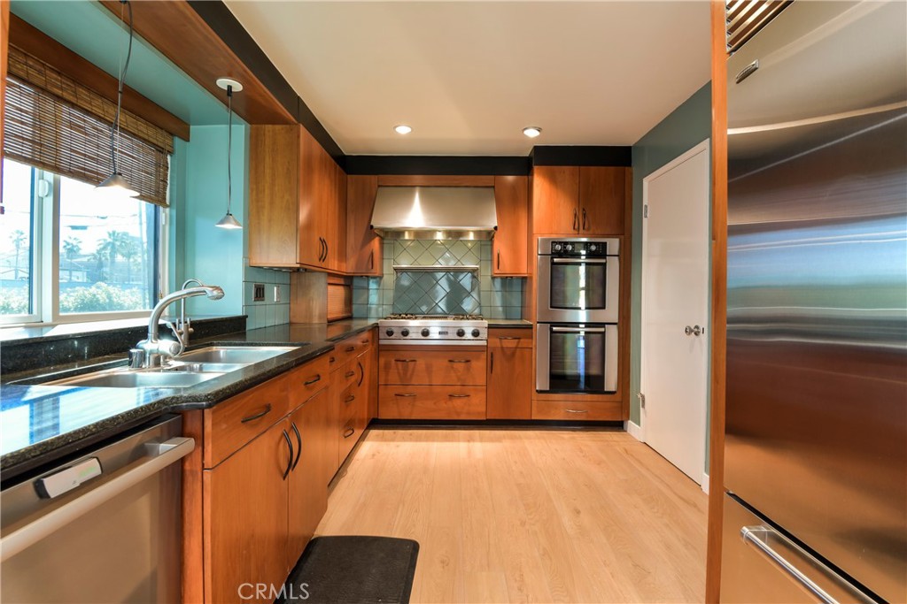1141 17th Street, Unit 5 Santa Monica, CA 90403 - Photo 22 of 43 a large kitchen with stainless steel appliances granite countertop a refrigerator and a sink