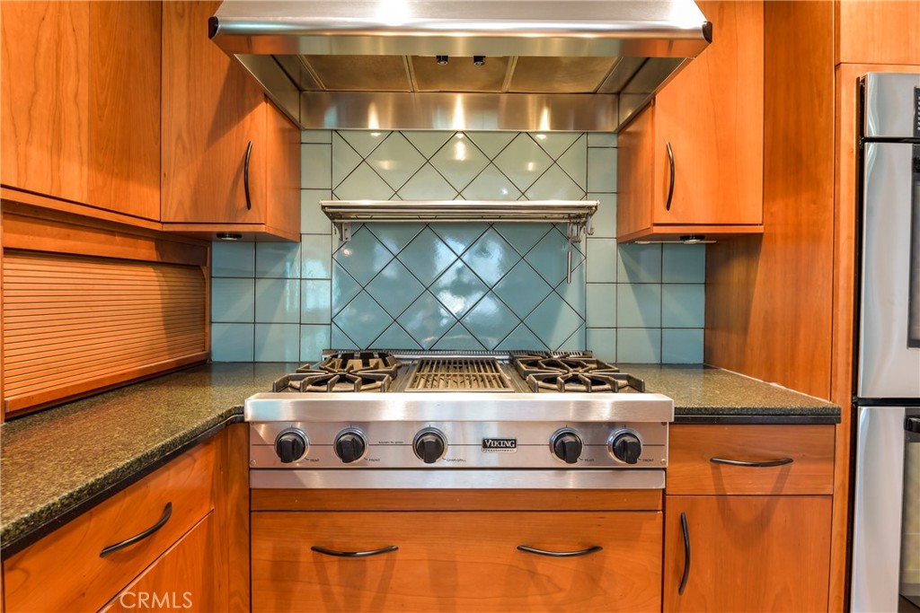 1141 17th Street, Unit 5 Santa Monica, CA 90403 - Photo 24 of 43 a white stove top oven sitting inside of a kitchen