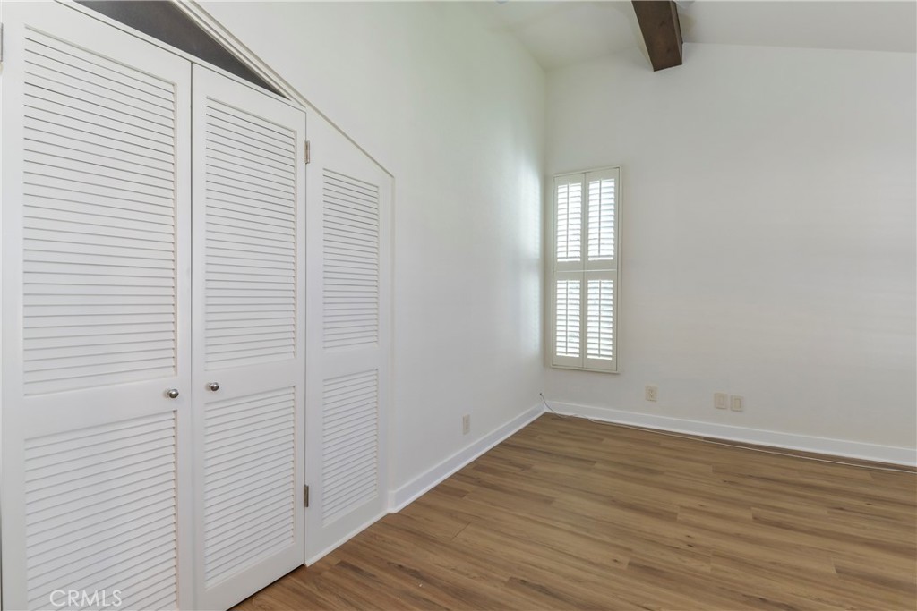 1141 17th Street, Unit 5 Santa Monica, CA 90403 - Photo 35 of 43 a view of an empty room with wooden floor and a window