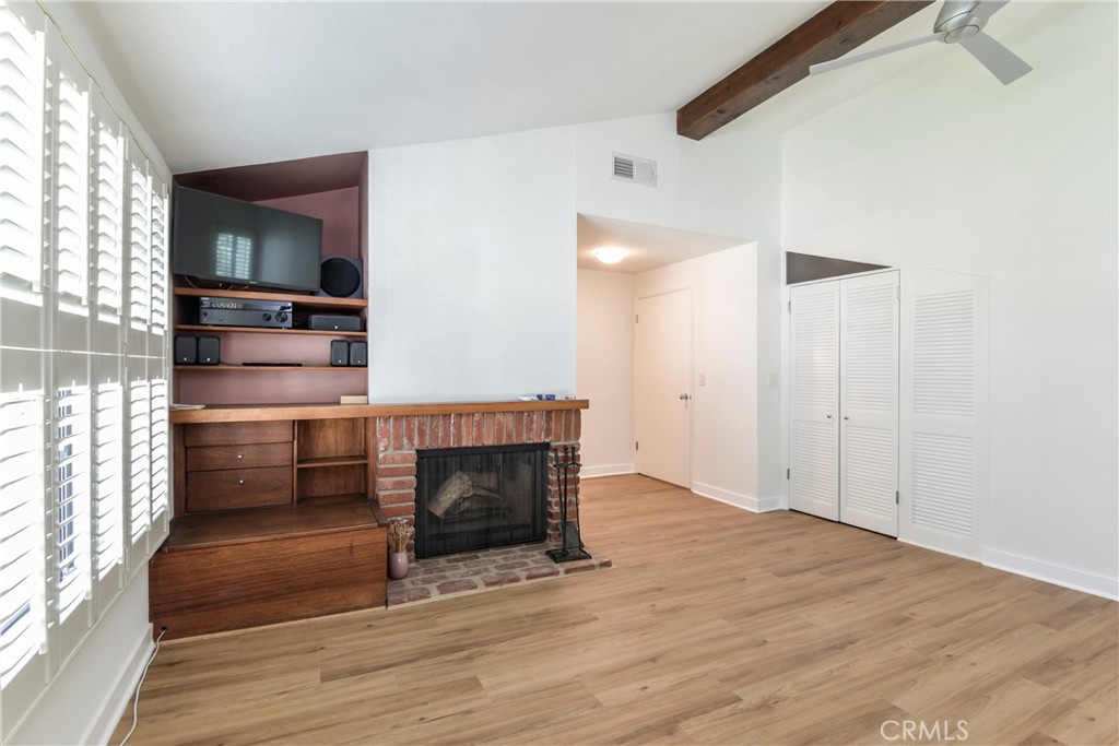 1141 17th Street, Unit 5 Santa Monica, CA 90403 - Photo 37 of 43 an empty room with wooden floor fireplace and windows