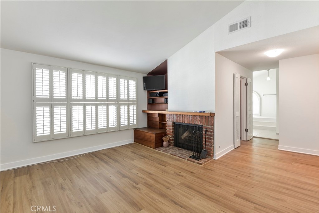 1141 17th Street, Unit 5 Santa Monica, CA 90403 - Photo 38 of 43 wooden floor fireplace and windows in an empty room