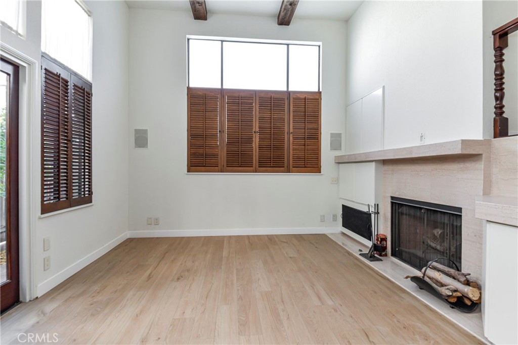 1141 17th Street, Unit 5 Santa Monica, CA 90403 - Photo 9 of 43 a view of empty room with wooden floor and fireplace