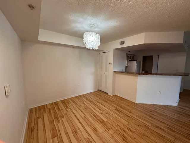 a view of a kitchen with wooden floor and a sink