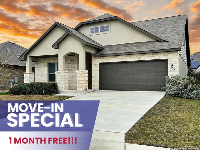 a front view of a house with a garage and yard