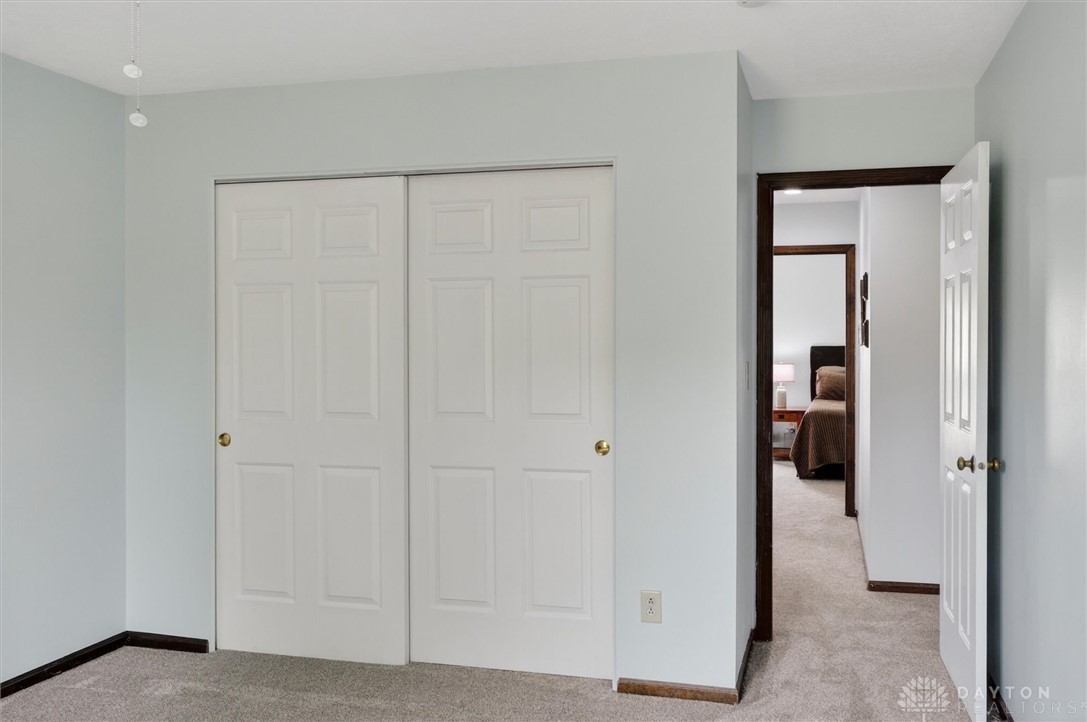 2165 Stewart Road Xenia, OH 45385 - Photo 30 of 59 This cozy bedroom features a spacious closet, offering ample storage and easy access.