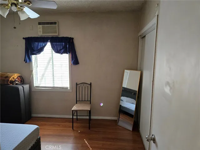 a view of room with window and wooden floor