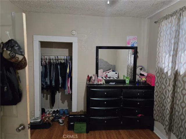 a room with a bed a dresser and a mirror