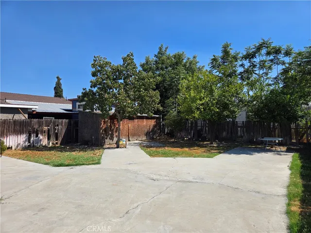 a view of a swimming pool with a patio and a yard