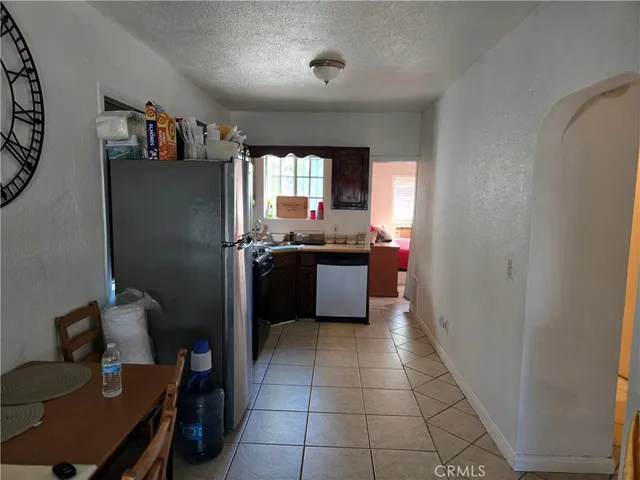 a kitchen with stainless steel appliances granite countertop a refrigerator and a stove