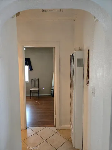 a view of a hallway with wooden shelves