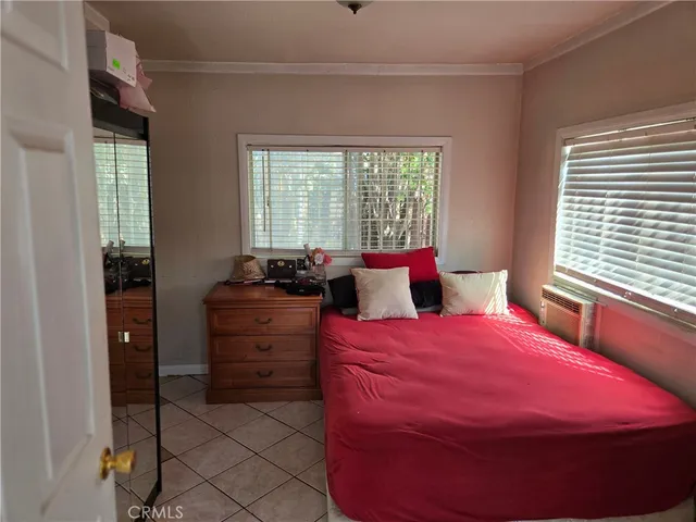 a bedroom with a bed and window