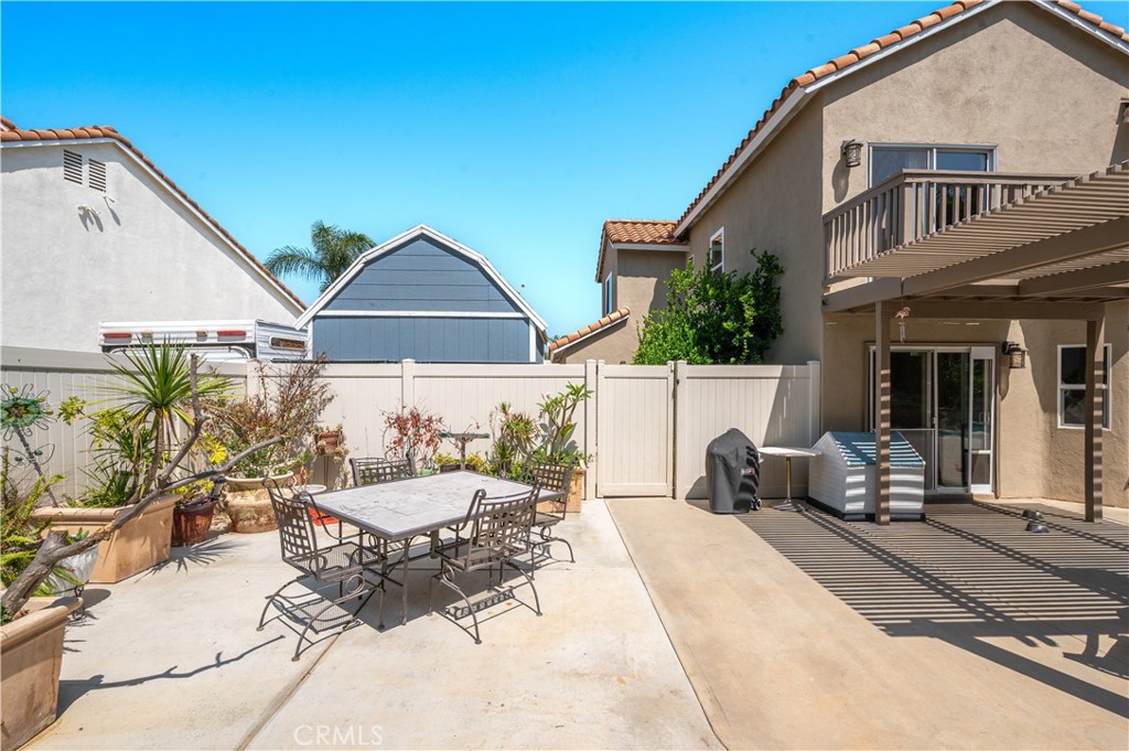 19465 Kinnow Lane Riverside, CA 92508 - Photo 46 of 61 a view of a patio with couches table and chairs and potted plants