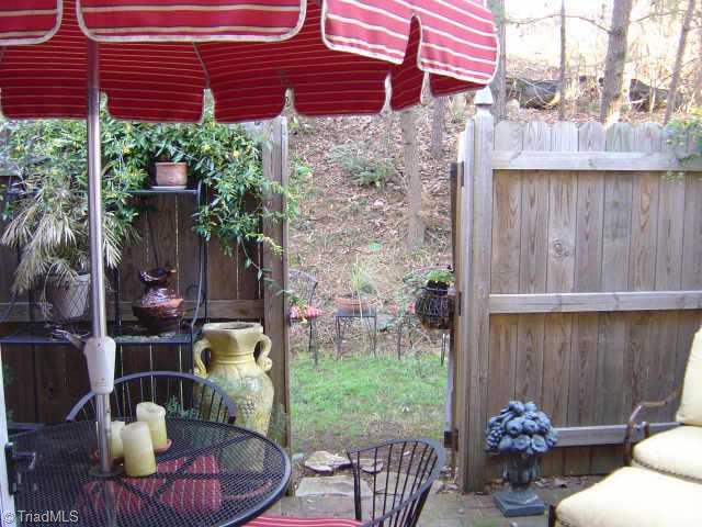 4908 Tower Road, Unit B Greensboro, NC 27410 - Photo 8 of 9 Other. Patio w/privacy fence opens to wooded area