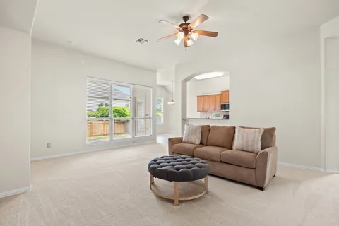 a living room with furniture and a large window