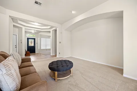 a living room with furniture and a rug