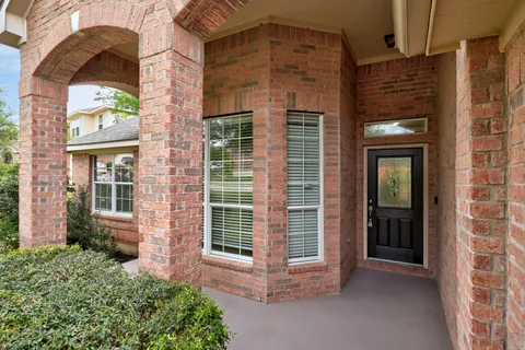front view of a brick house with a large window