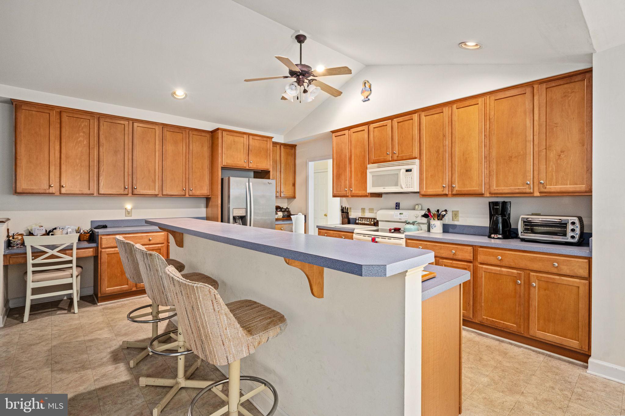 209 Edgemont Lane Locust Grove, VA 22508 - Photo 12 of 48 a kitchen with granite countertop a stove top oven cabinets and a refrigerator