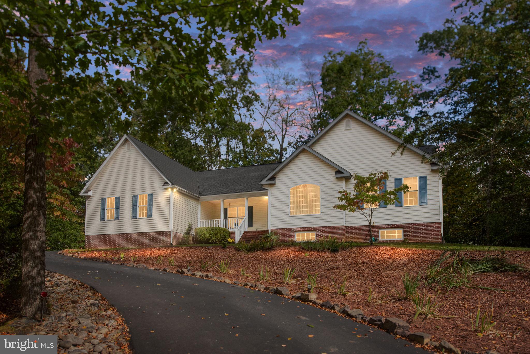 209 Edgemont Lane Locust Grove, VA 22508 - Photo 36 of 48 a front view of a house with a yard and garage
