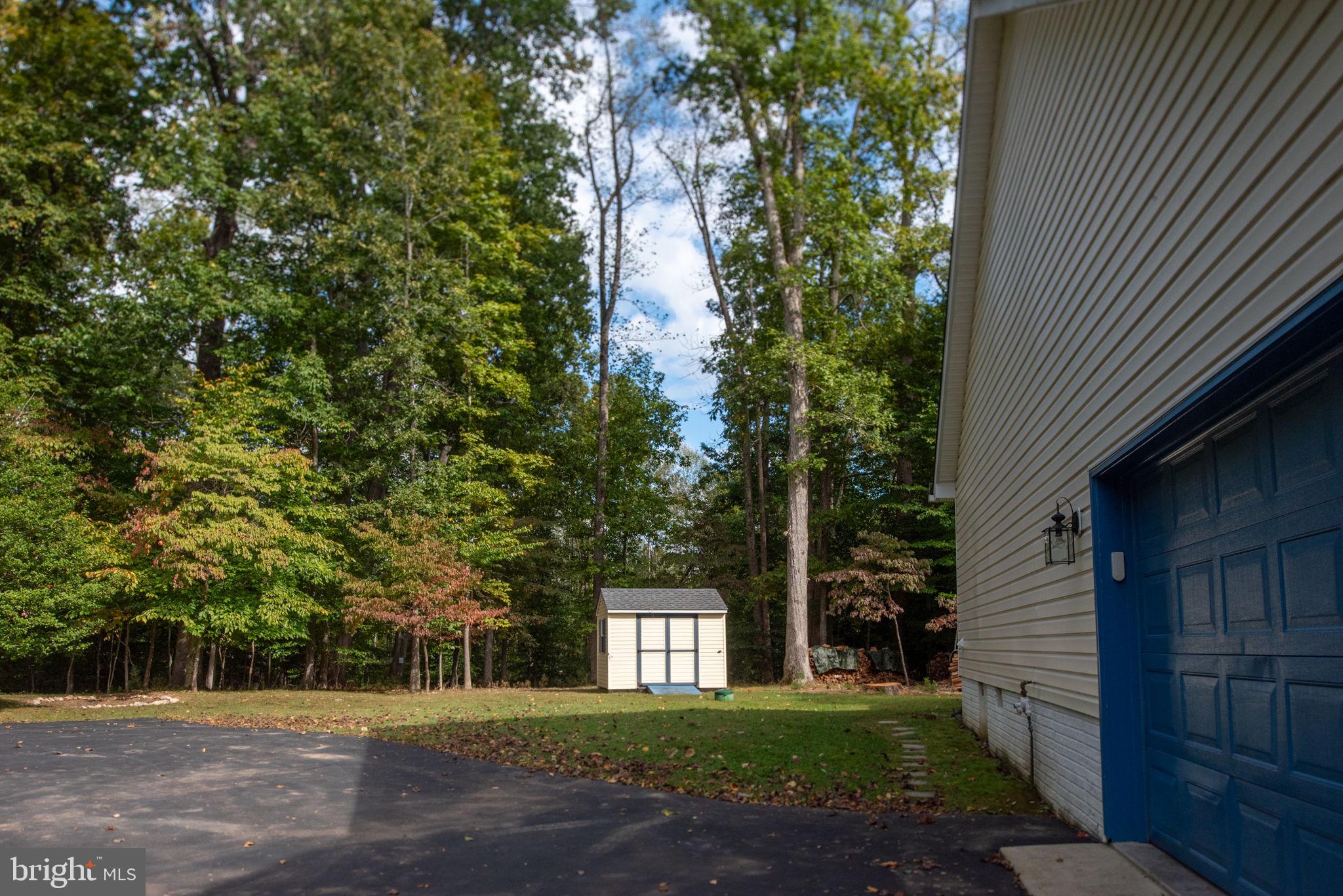 209 Edgemont Lane Locust Grove, VA 22508 - Photo 43 of 48 a front view of a house with a garden