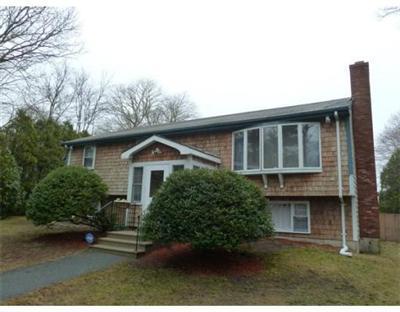 2 Quamhassett Road Buzzards Bay, MA 02532 - Photo 3 of 12 a front view of house with yard and trees around