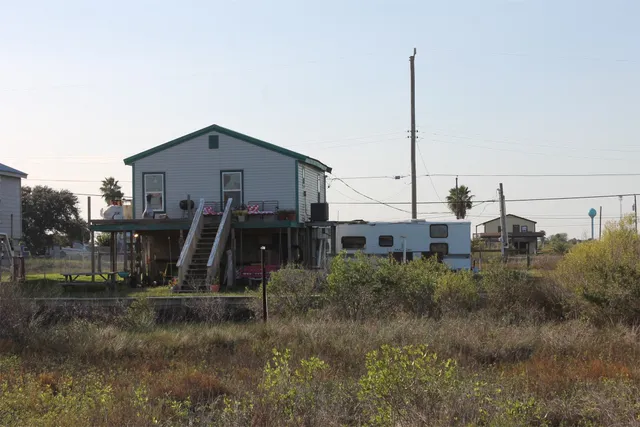 a view of a house next to a yard