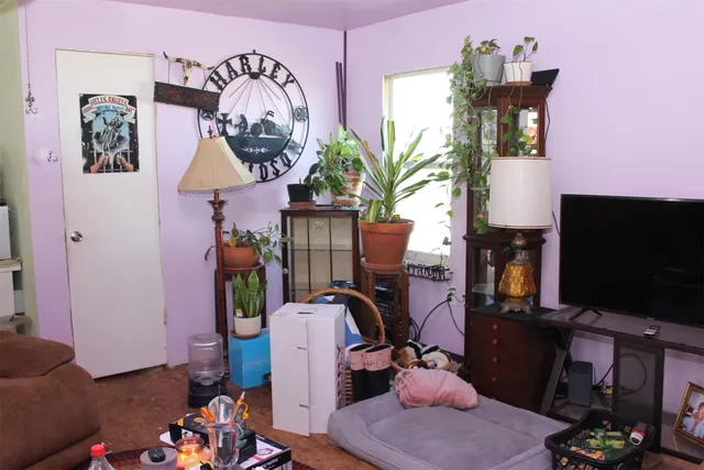 a kitchen with a refrigerator and a stove top open