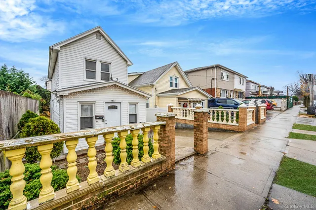 a view of a house with wooden fence