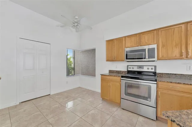 a kitchen with stainless steel appliances granite countertop a stove a sink and a refrigerator