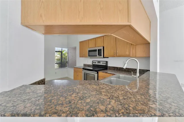 a kitchen with a stove a sink and a refrigerator