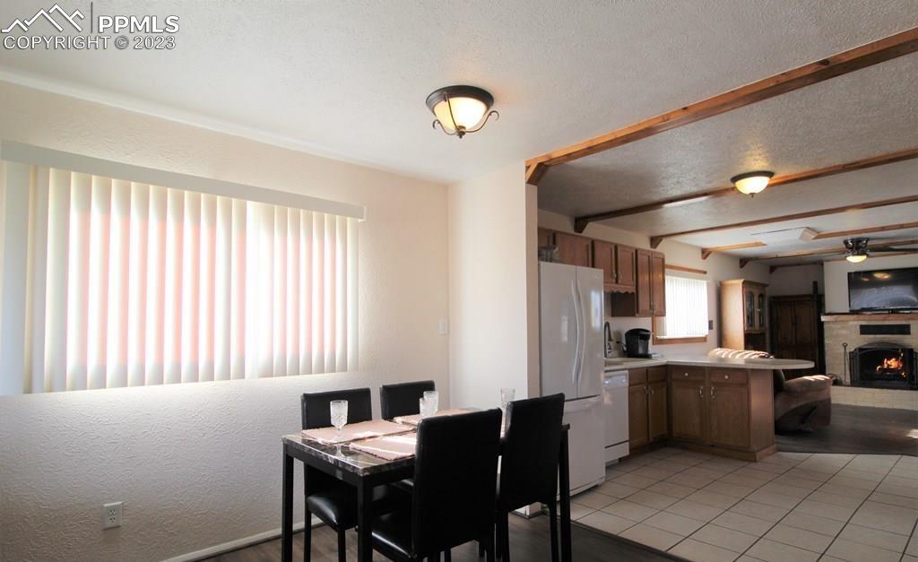 210 4th Street Fowler, CO 81039 - Photo 5 of 18 a kitchen with a dining table chairs and refrigerator