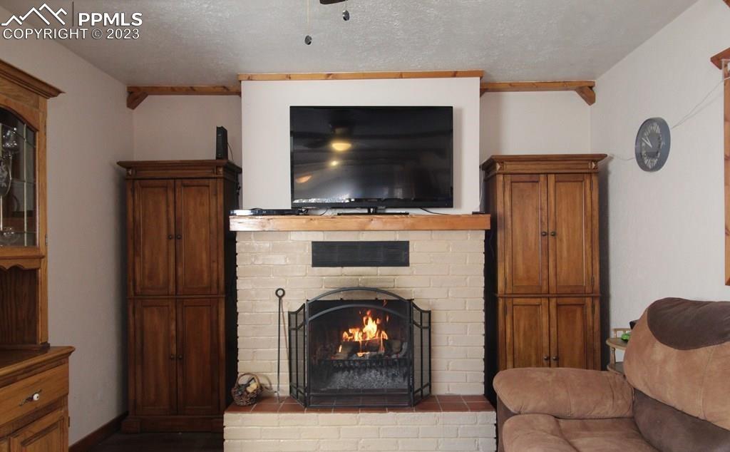 210 4th Street Fowler, CO 81039 - Photo 8 of 18 a living room with furniture and a fireplace